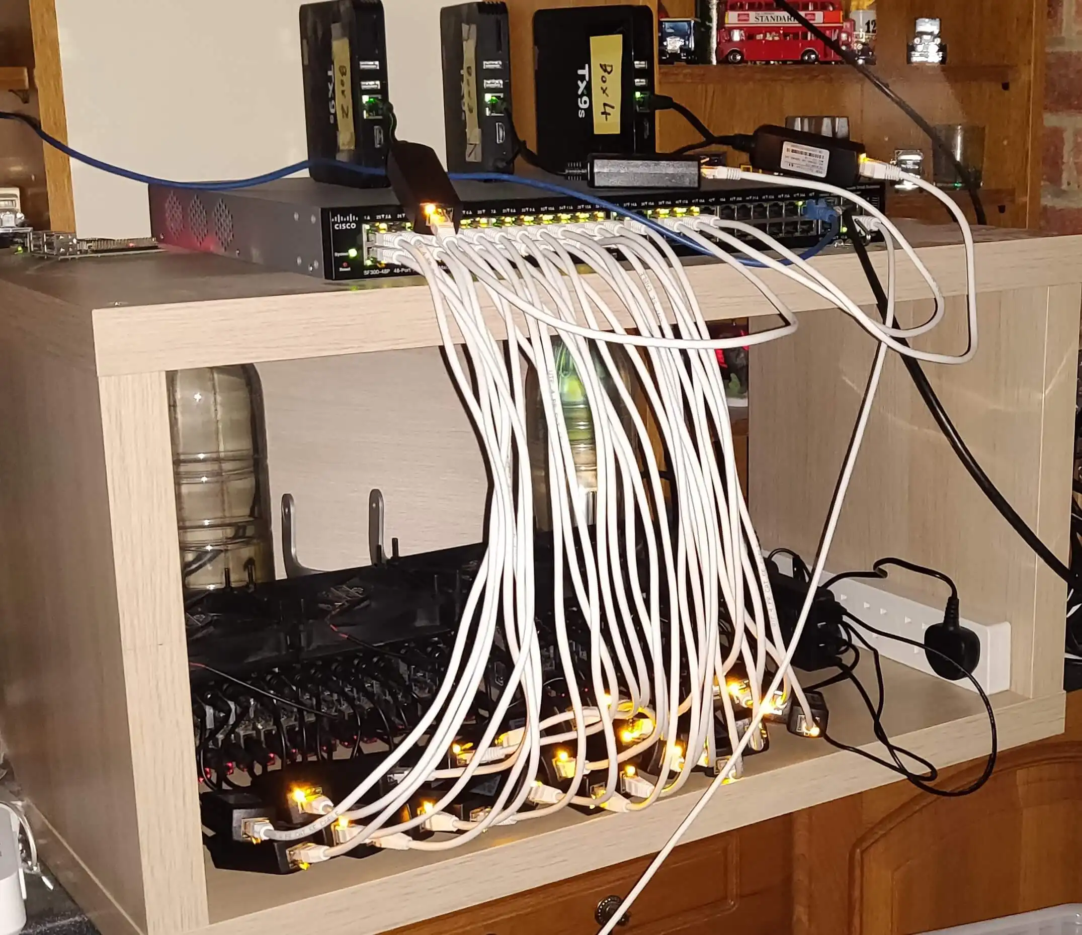 A 32 port Cisco POE Switch supporting a large mix of Android Boxes. All placed inside an IKEA shelf for cleaner storage.